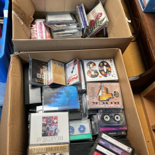 Large lot of vintage CDs and tapes for music collectors.