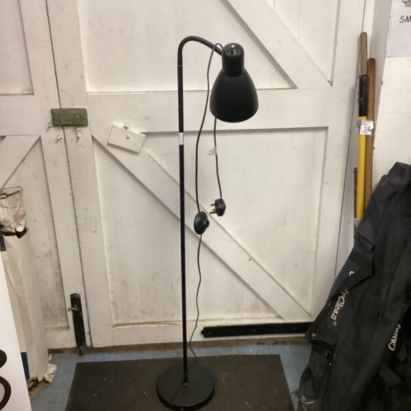 Black vintage floor lamp with adjustable head and circular base.