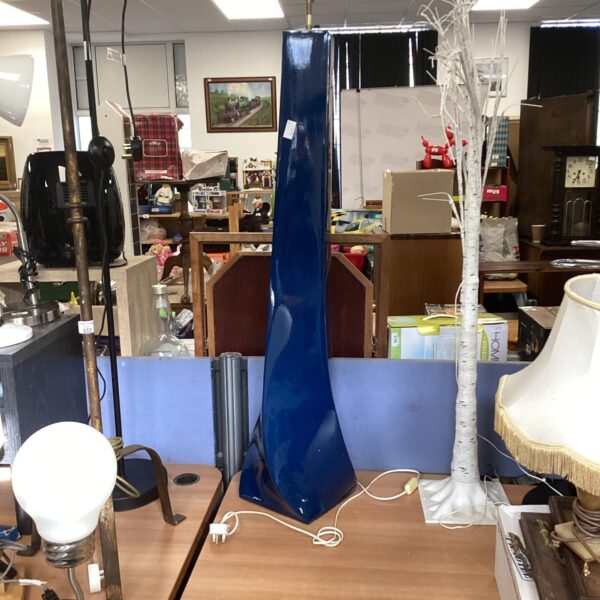 Bold blue modernist standard lamp in a vintage setting.