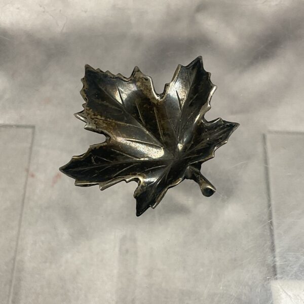 Vintage sterling silver maple leaf brooch, detailed and elegant.