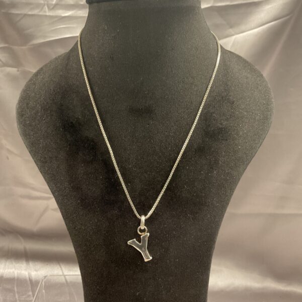 Close-up of Links of London silver necklace with a Y pendant.