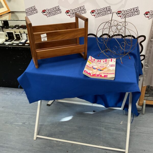 Two retro wooden magazine racks with a vintage magazine.