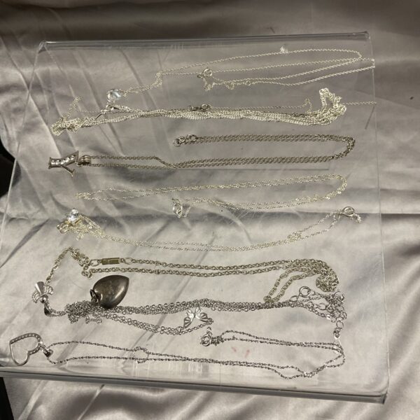 Lot of 925 sterling silver necklaces with varying styles.