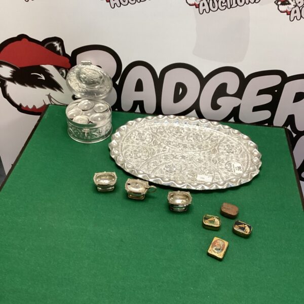 Vintage silverplate tray with mixed collectibles on display.