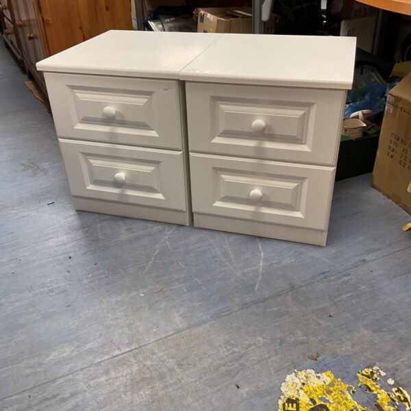 Pair of white bedside cabinets for bedroom storage.