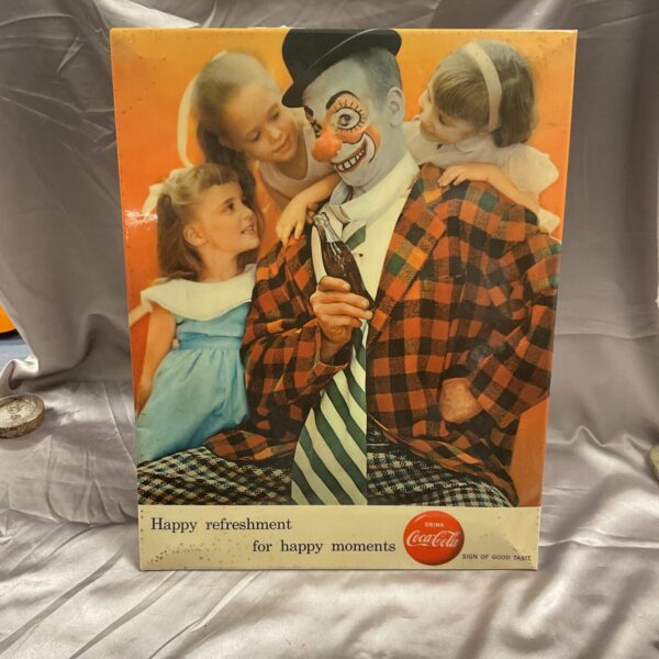 Vintage Coca Cola counter display featuring a clown design.