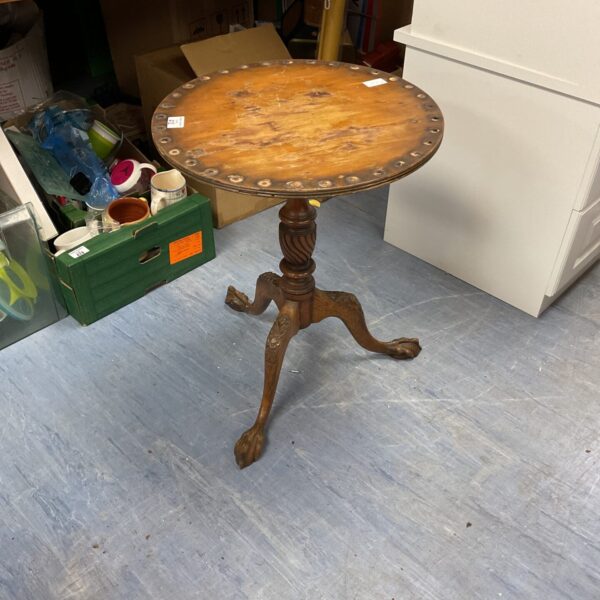 Antique wine table with claw feet and mahogany top.