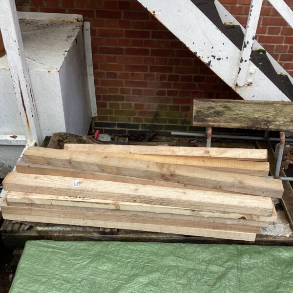 Stack of rough sawn timber planks for DIY projects.
