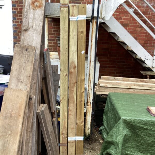Stack of rough sawn timber lengths for construction projects.