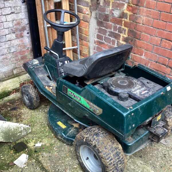 Hayter ride on mower in a garden setting.