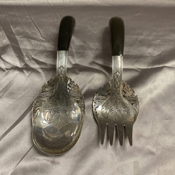 Vintage Malaysian silver serving spoons with horn handles.