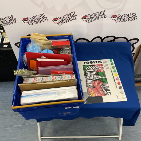 Plastic crate filled with mixed arts and crafts supplies.