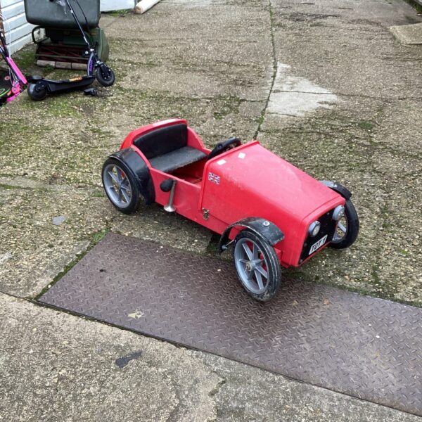 Red vintage child's ride in car with Makita motor.