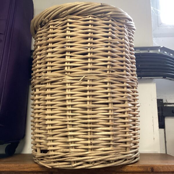 Vintage wicker laundry basket for storage and rustic decor.