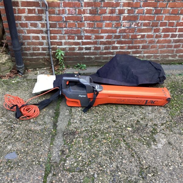 Side view of a used Flymo electric leaf blower and lawn vac.