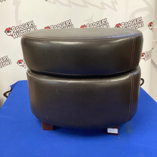 Comfortable brown leather footrest for home decor.