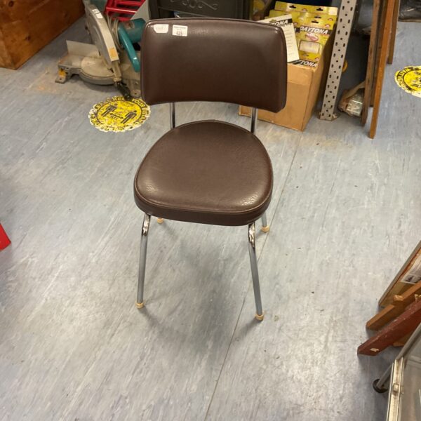 Vintage leatherette chair with chrome legs, mid century modern style.