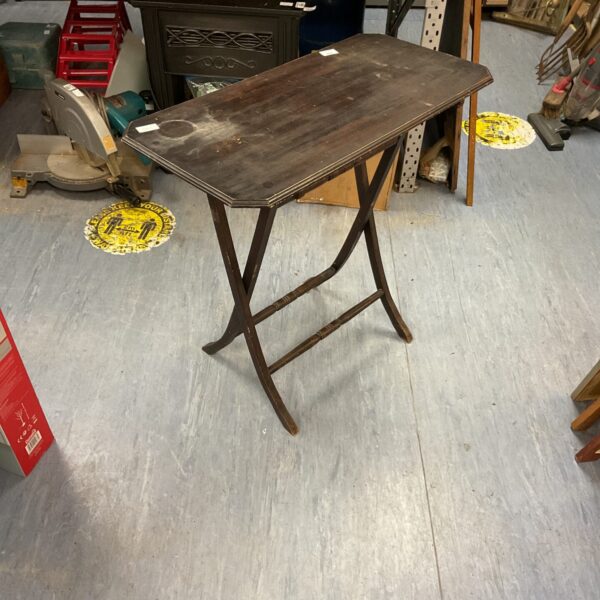Vintage wooden folding table with tripod legs.