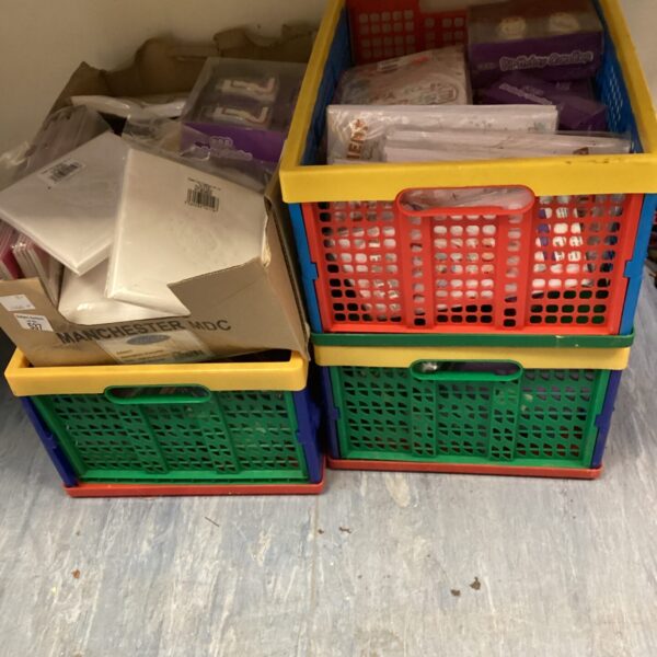 Brightly coloured boxes filled with party supplies and celebration cards.