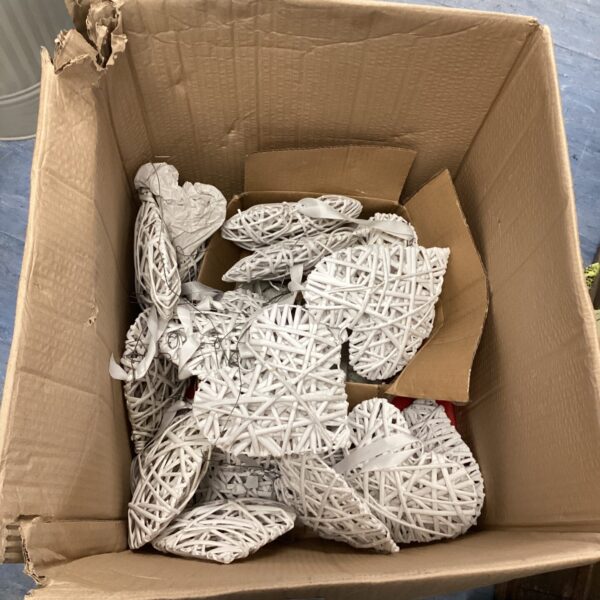 Box of woven wooden hanging hearts for rustic decor.