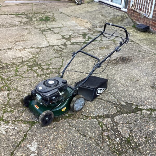 Sanli petrol lawn mower in a garden setting.