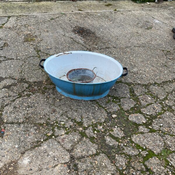 Vintage blue enamel washing basin with white interior.