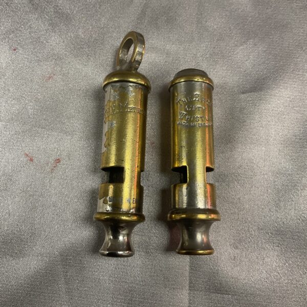 Antique Metropolitan and Emca City police whistles, brass collectible.
