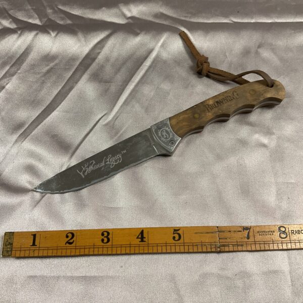 Browning Whitetail Legacy knife with wood handle and deer motif.