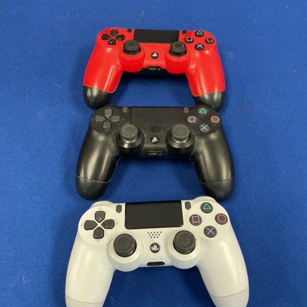 Lot of three Playstation 4 controllers for gaming.