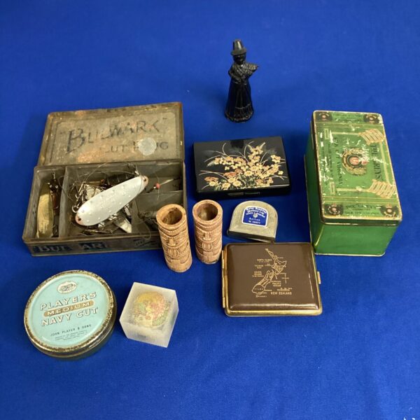 Vintage fishing lures and decorative tins in a mixed lot.