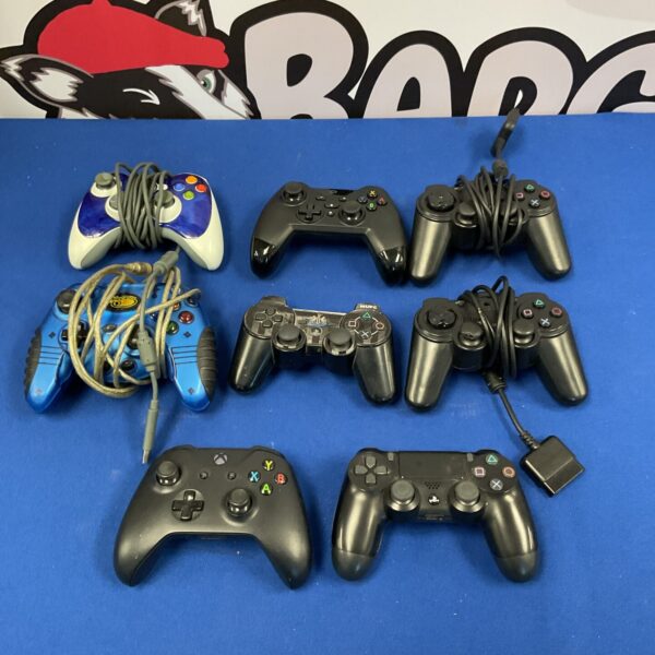 Vintage PlayStation and Xbox controllers in a lot for collectors.