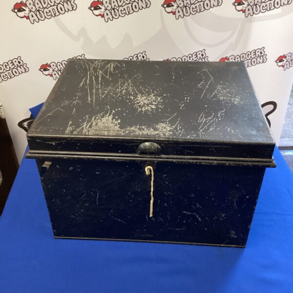Vintage metal lock box with key for secure storage.