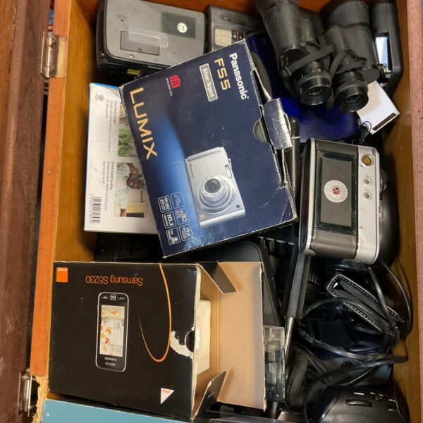 Vintage Hanimex 3000 camera within a lot of cameras and electronics.