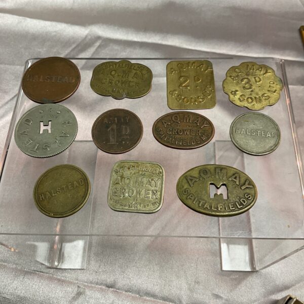 Antique Spitalfields Market tokens with varying denominations.