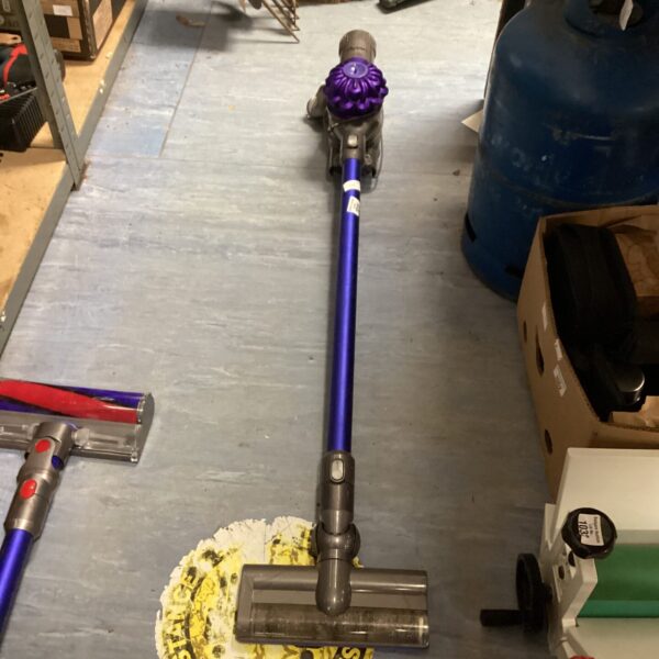Purple and silver Dyson V8 cordless stick vacuum cleaner.