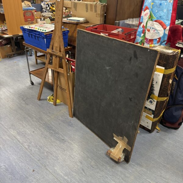 Vintage slate blackboard with wooden stand, classic school equipment.