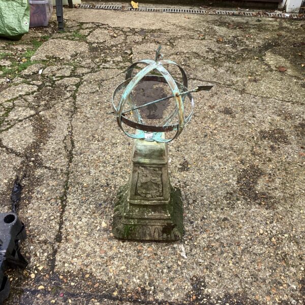 Antique stone sundial in a garden setting.
