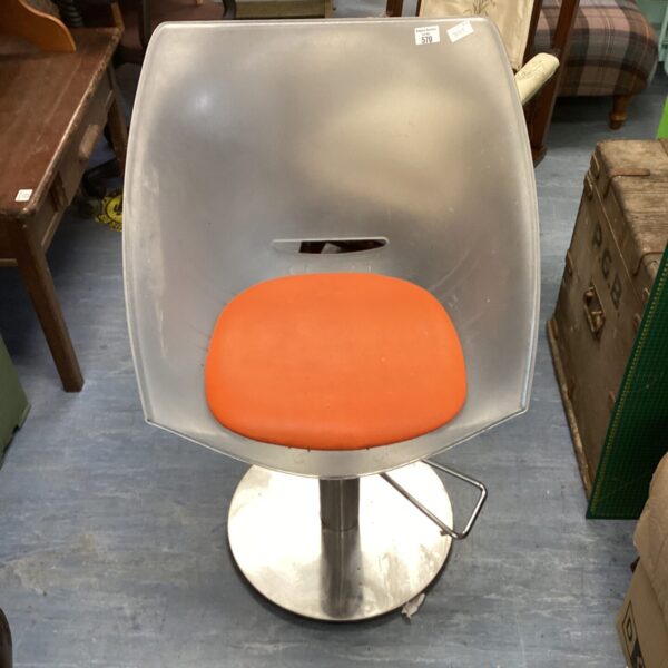 Vintage chrome retro swivel chair with orange seat.