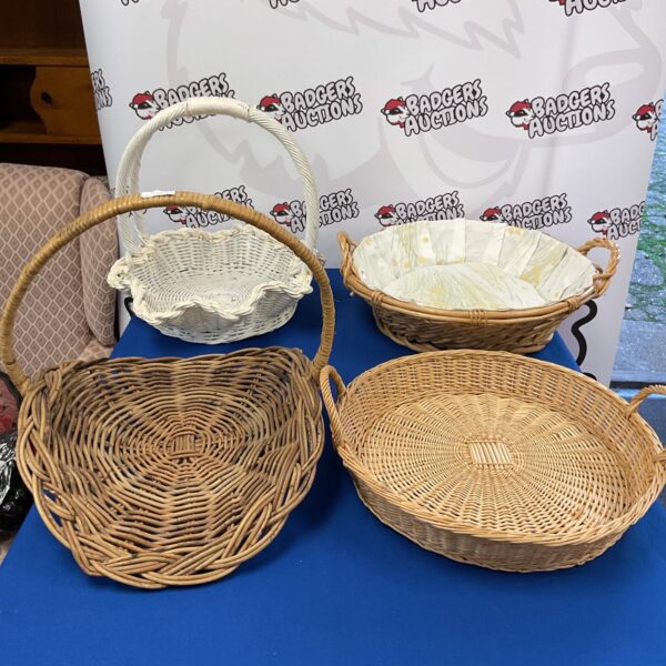 Four vintage wicker baskets displayed together.