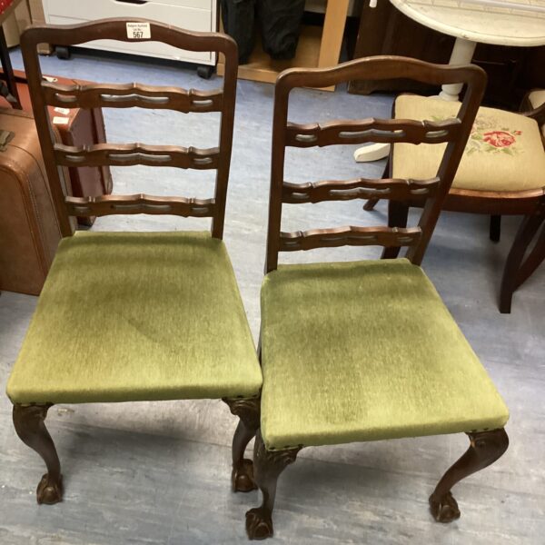 Pair of antique claw foot chairs with upholstered seats.