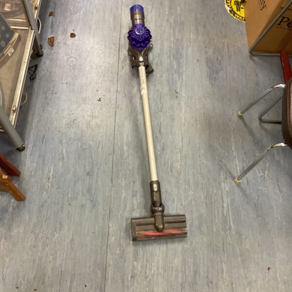 Front view of a used Dyson V6 cordless vacuum cleaner.