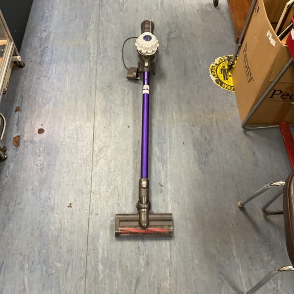 Dyson V6 Animal cordless vacuum cleaner in a home setting.