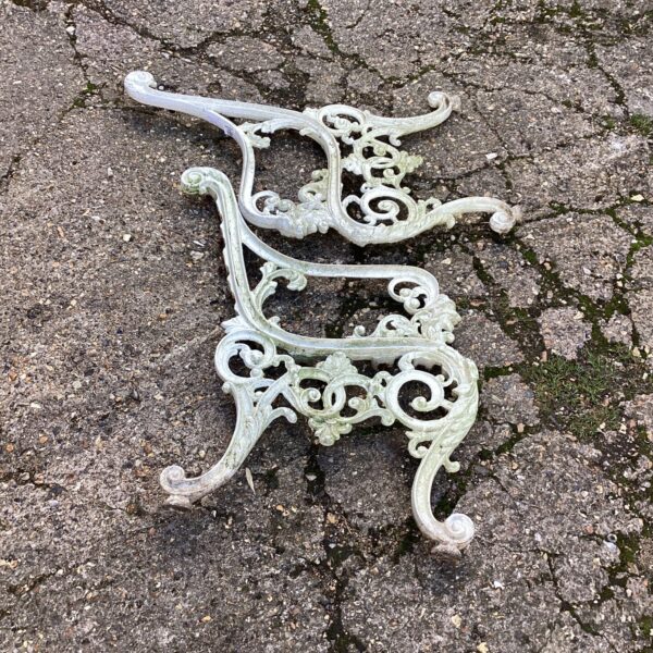 Intricate Victorian metal bench ends for garden restoration.