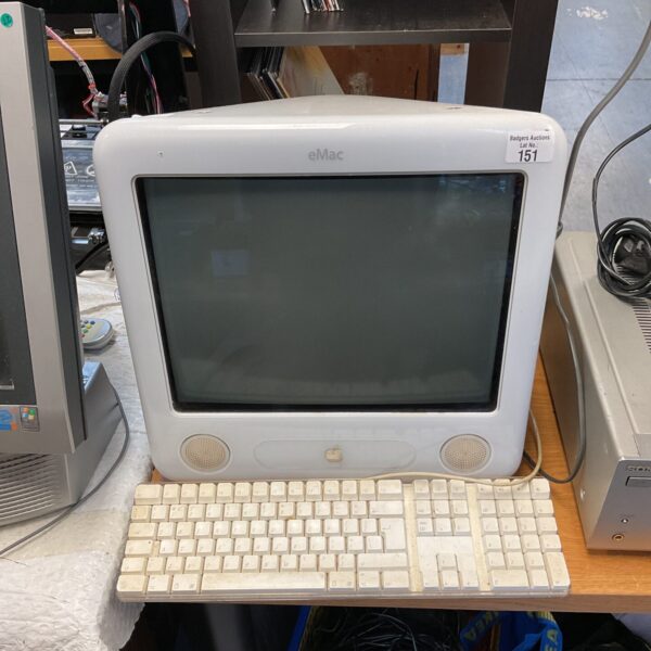 Front view of a vintage Apple eMac computer with keyboard.