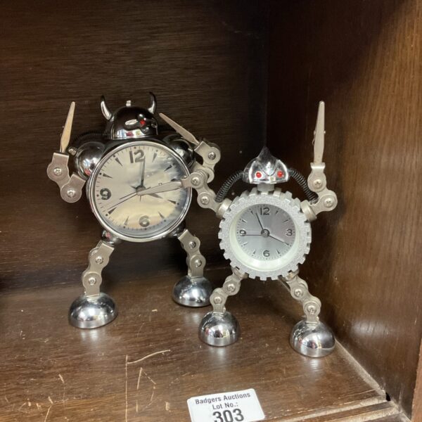 Vintage robot clock pair, collectible novelty item.