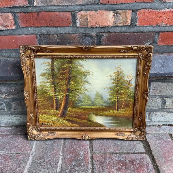 Vintage Charles woodland river oil painting with gilt frame.