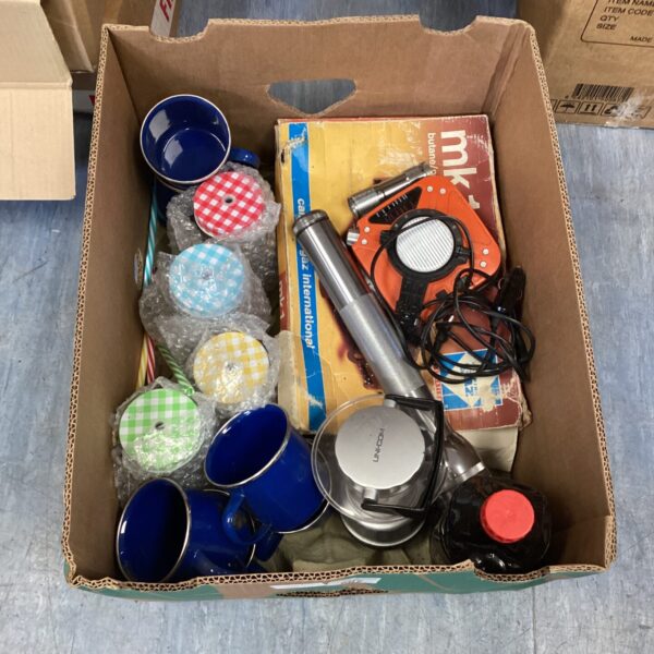 Mixed lot of vintage mugs and blue tin cups on display.