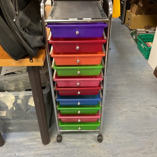 Colourful rolling storage trays on wheels for workshop or craft use.