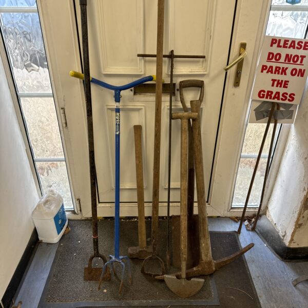 Vintage garden tool lot featuring a sledge hammer and pickaxe.