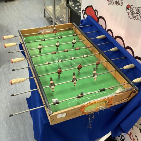 Vintage table football game with green felt surface.